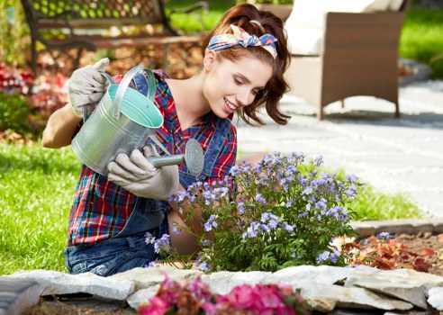 A gardener planting flowers in a small urban garden in Elephant and Castle